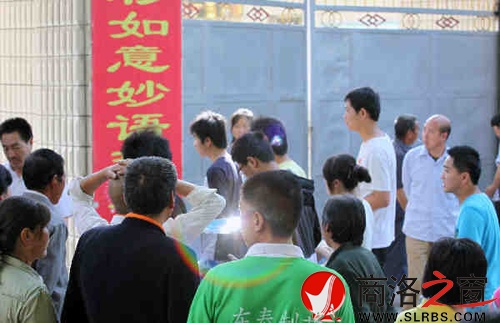 家們送考生進(jìn)入考場時，一縷光環(huán)閃現(xiàn)鏡頭中，這也許就是人們的理想與期待.jpg